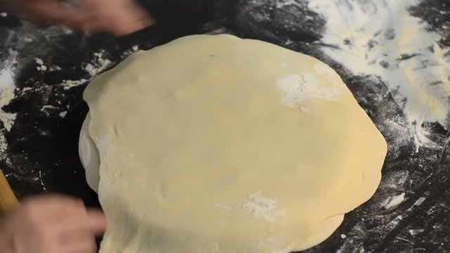 Cook kneads dough on dumplings with minced meat on a special form