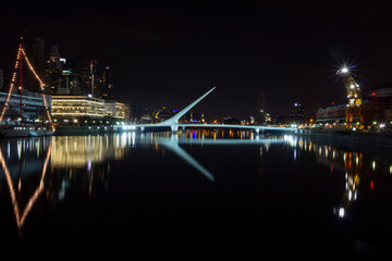 Fototapeta na wymiar Night view of iconic landmark city of Buenos Aires El Puente de La Mujer, or Woman's Bridge.Puerto Madero Buenos Aires Argentina.