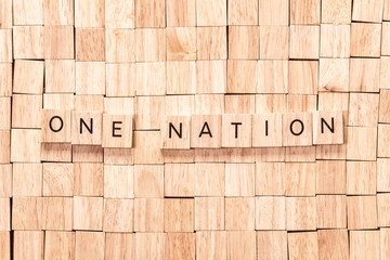 One nation spelled out in wooden letters