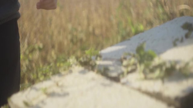 Young hipster man stroking vine on cinderblock in slow motion