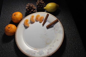 tangerines and cinamon on white plate