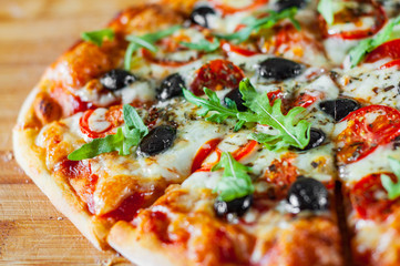 Pizza Margherita or Margarita with Mozzarella cheese, tomato, olive. Italian pizza on wooden background
