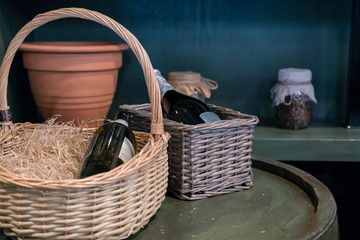 Bottle wine in basket with straw. Rustic style