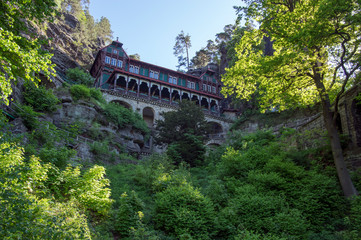 Fototapeta na wymiar Pravcicka brana is a narrow rock formation located in Bohemian Switzerland, late spring scenery with greenery, blue sky