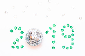 2019 lined with sequins on white background. Christmas composition. Top view, copy space
