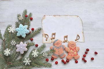 Gingerbread  man with christmas tree on wooden background 