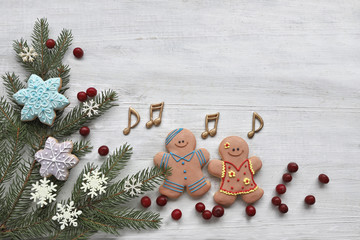 Gingerbread  man with christmas tree on wooden background 