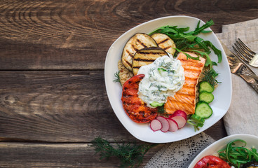 Grilled salmon, eggplants and tomatoes with quinoa and tzatziki sauce