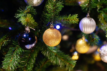 Decorated Christmas tree on blurred, sparkling background