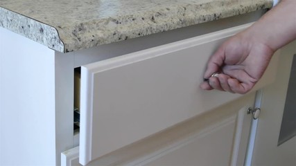 Man is an opening and closing  empty drawer 