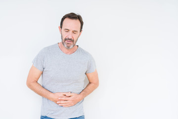 Obraz premium Handsome senior man over isolated background with hand on stomach because indigestion, painful illness feeling unwell. Ache concept.