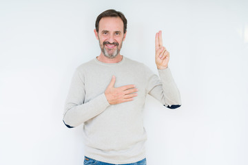 Elegant senior man over isolated background Swearing with hand on chest and fingers, making a...