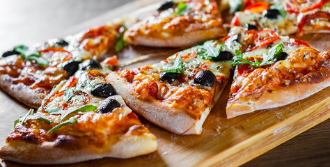 Pizza Margherita or Margarita with Mozzarella cheese, tomato, olive. Italian pizza on wooden background