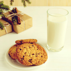 Milk and cookies for Santa Claus under the christmas tree. Concept, copy Space.