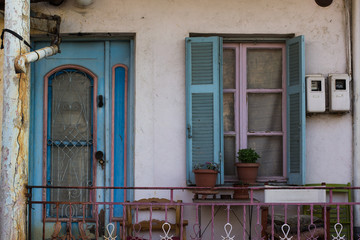 Fototapeta na wymiar cheap exterior village back yard apartment building balcony facade with wooden door and window
