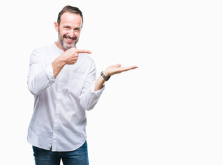 Middle age hoary senior man over isolated background amazed and smiling to the camera while presenting with hand and pointing with finger.