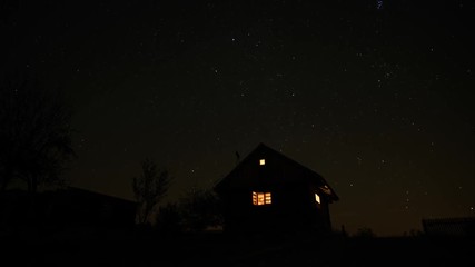 Night time lapse of a wooden cabin and amazing starry sky behind it. - Powered by Adobe