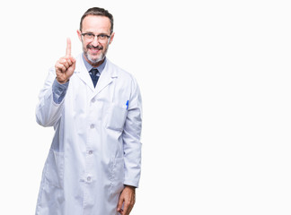 Middle age senior hoary professional man wearing white coat over isolated background showing and pointing up with finger number one while smiling confident and happy.