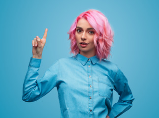 Colorful trendy woman pointing up