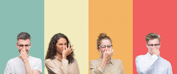 Collage of a group of people isolated over colorful background smelling something stinky and...