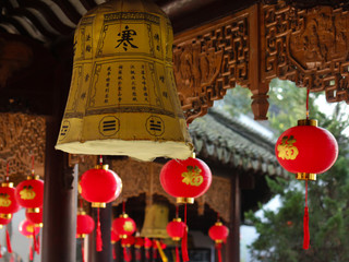 Exterior hallway decorated with red and yellow traditional lanterns with religious inscriptions in a temple in China, Asia