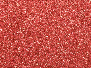 Fototapeta premium Sparkling background made of Living Coral 2019 lights. Festive blurred backdrop for holidays and parties. Top view or flat lay. Copy sace for text