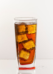Cold refreshing soft drink with ice on a white background