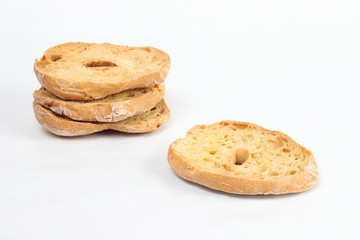 Freselle or friselle, dried bread typical of the ancient tradition of southern Italy. The picture shows some slices with a central hole on a white background. Copyspace