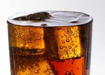 Cold refreshing soft drink with ice on a white background