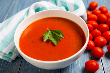 Healthy Tomato Soup on wood background