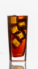 Cold refreshing soft drink with ice on a white background