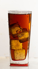 Cold refreshing soft drink with ice on a white background
