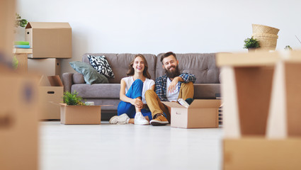 happy young married couple moves to new apartment