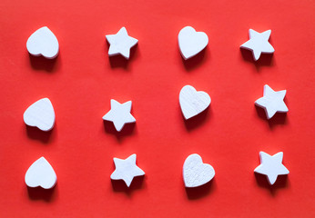 Valentines Day concept.Pattern of wooden white heart and star decorations on the background of living coral. Color of the year 2019 concept.  Top view. Copy space, closeup.
