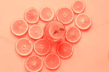 Detox-Orangencocktail im Glasbecher auf Living Coral-Hintergrund. Konzept von gesunden Getränken. Kopieren Sie Platz, Nahaufnahme, flaches Lay.Draufsicht. © Nataliia