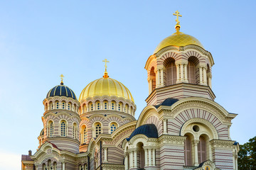 Fototapeta na wymiar Religious building, Orthodox Christian cathedral with golden domes. Riga Nativity of Christ Cathedral.