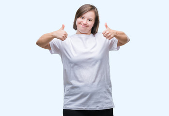 Young adult woman with down syndrome over isolated background success sign doing positive gesture...