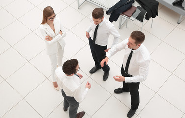 top view.a group of business people talking standing in the office