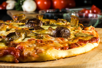 Baked pizza homemade with cheese and wild mushrooms.