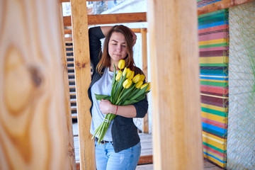 Beautiful woman stands with flowers