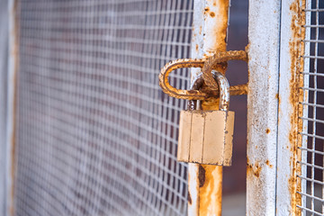 Locked gates with old rusty lock