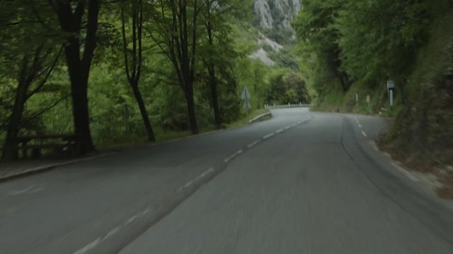 Fast pace on col de turini road. Shot from hood of a old car