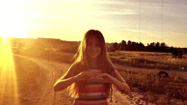 Litttle girl wawing her long hair at sunset, slow motion in retro style