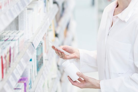 Pharmacist reading prescription