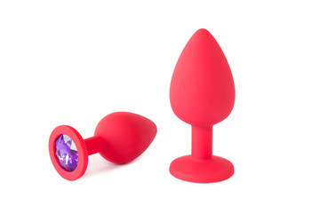 Two red silicone butt or anal plugs, isolated on a white background.