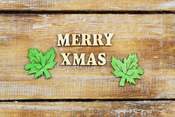 Merry Christmas written with wooden letters on rustic surface
