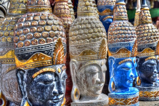 Colorful Buddha statues in a souvenir shop at the Pura Tirta Empul Temple in Bali Island, Indonesia