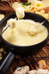 Gourmet Swiss fondue dinner on a winter evening with assorted cheese