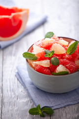 grapefruit plate on wooden background. Citrus diet