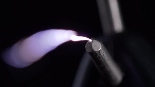 STUN GUN FIRES TOWARDS CAMERA.  MACRO ECU OF ARCING ELECTRICITY.  4K, 10 BIT, 4:2:2.
